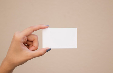 Obraz premium Women holding white business card mockup on isolated background