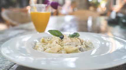 A dish of the Carbonara paste with seafood in a big white plate.