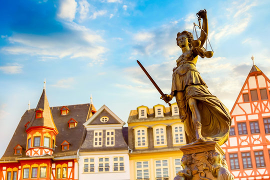 Old town square Romerberg with Justitia statue in Frankfurt Main, Germany with blue sky