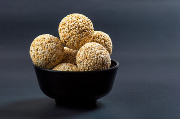 Amaranth or Rajgira laddu, Cholai ke laddo in black Bowl on black background
