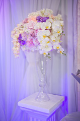Decorative bouquets of flowers in vases as decoration of the wedding tab
