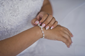 The woman touches the pearl bracelet on her hand 2296.