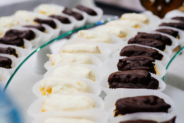 Eclairs with black and white chocolate.