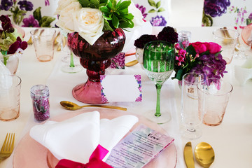 Dinning table colorfully decorated with flowers and fruits