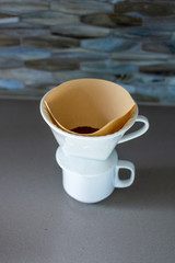 making pour over coffee with a stainless steel kettle on a gas stove