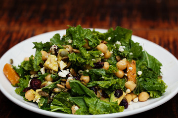 Healthy green kale salad with chickpeas, feta cheese, nuts