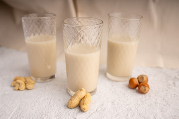 Three glasses with different types of organic milk. Nut milk without lactose, gmo, antibiotics and casein. Diet drink.