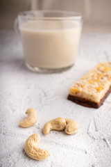Healthy breakfast. Organic milk. Cereal granola bar. Glass cup with organic milk. Nut milk without lactose, gmo, antibiotics and casein. Diet food.  ..