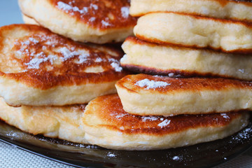 Fresh homemade pancakes on a plate on the table. Close-up. Background.