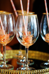 Glass with a decorative ice fusion and a pink straw