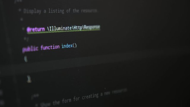 The programming cyberwork performed on a big black pc screen with many signs 