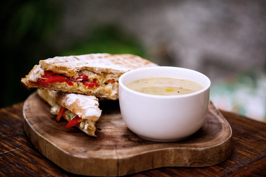 Delicious soup accompanied with sandwich