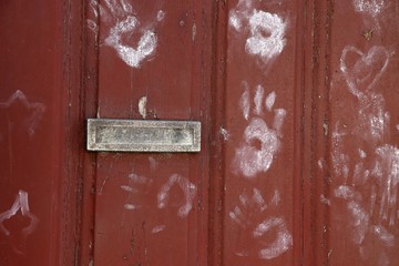 Old Wooden Door with post box . Palm prints on the door, Portugal lettering Correio  on the mail box cover,