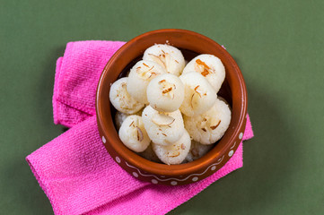 Indian Sweet - Rasgulla, Famous Bengali sweet in clay bowl with napkin