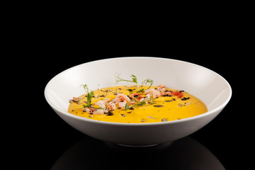 Delicious pumpkin soup in a bowl, closeup, horizontal orientation.