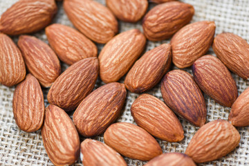 Close up almond nuts natural protein food and for snack - Almonds on sack background