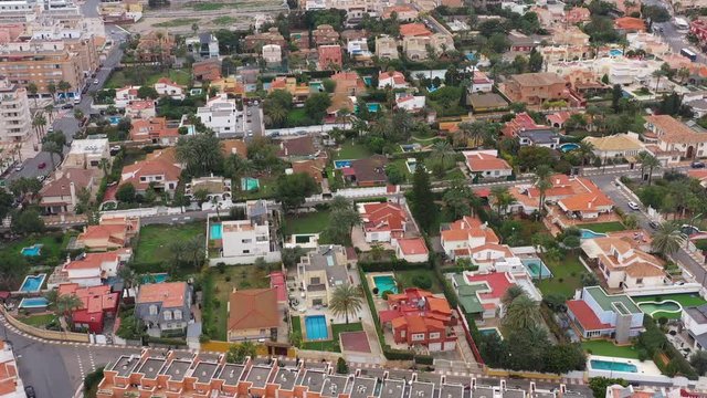 luxurious villas in Roquetas de Mar aerial view pools and palm trees houses residential neighbourhood Spain