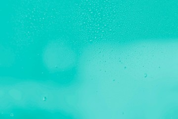 Raindrops on window glass. Mint aquamarine color gradient abstract background