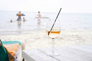 glass of white wine on the beach