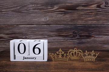 Epiphany Day Concept. 6 January calendar with tree kings crown on a wooden background