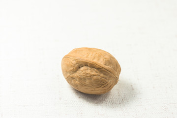 A walnut stands alone on  white background