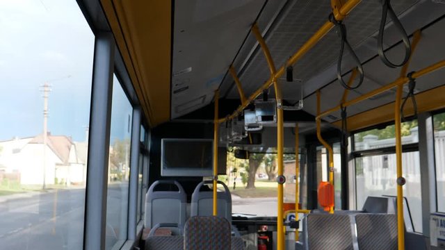 Blurred view of empty bus interior and street travelling in the town bus in Panevezys, Lithuania.