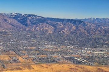 Wasatch Front Rocky Mountain Range Aerial view from airplane in fall including urban cities and the Great Salt Lake around Salt Lake City, Utah, United States of America. USA.