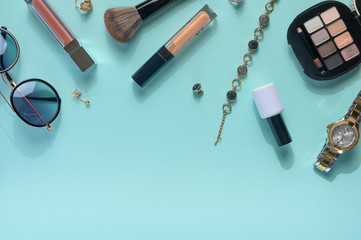 Obraz premium Women's accessories, a background from women's cosmetics, with creative color. A frame for writing. Creative light. Blue background.