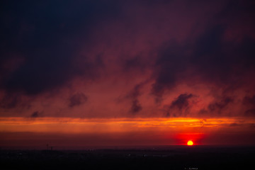 Epic Sunset. Sky. Foggy Clouds. Apocalypse. The sky before a thunderstorm. horizon. Gloomy clouds. End of the world. threat. Epic dramatic sunset