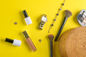 Blogging Beauty Concept. Professional women’s cosmetics, accessories, watches, bracelet, handbag. Female ideas and background. Yellow