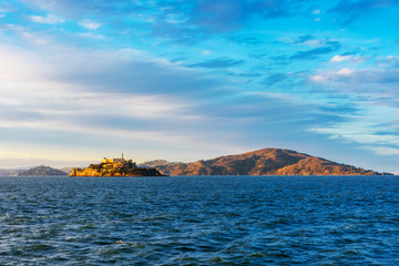 Sunset view of scenic San Francisco Bay coastline from the pier in San Francisco in the direction of Tiburon, Alcatraz and Angel islands - obrazy, fototapety, plakaty