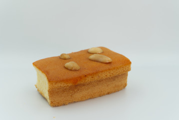 Egg Cake with cashews in white background.