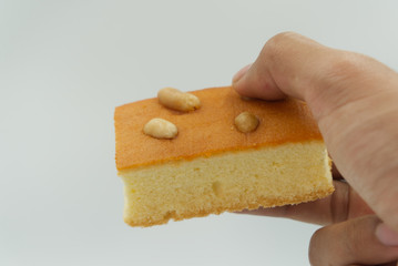 Egg Cake with cashews in white background.