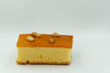 Egg Cake with cashews in white background.