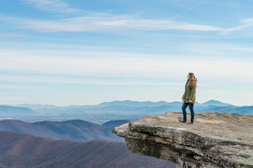 Young woman on the observation point on McAfee Knob
