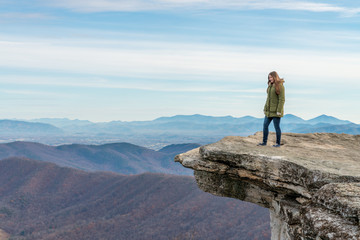 Young woman on the observation point on McAfee Knob