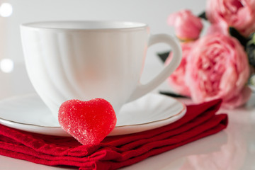 Fototapeta na wymiar White cup for coffee on a red napkin