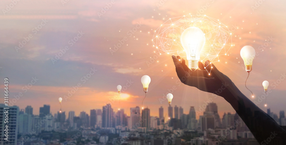 Poster hand holding light bulb and brain and network connection on city background, idea and imagination, c