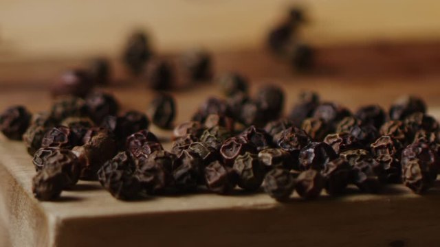 Scattering black pea pepper on kitchen table macro shot, cooking process, slow motion, shot on Red Weapon Helium 8k