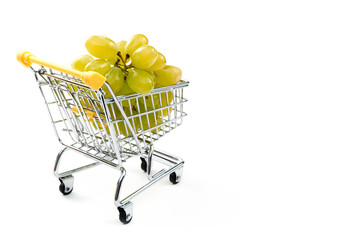 A grape in shopping cart isolated on white background. Ripe tasty green grapes in shopping cart....