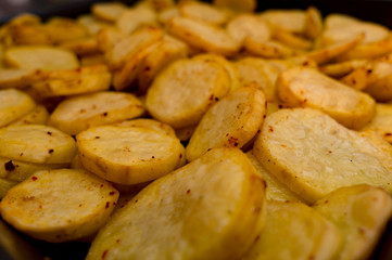 frying potatoes in pan with oil, top view