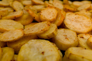 frying potatoes in pan with oil, top view