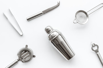 Bartender equipment set with shaker and stainer on white background top-down pattern