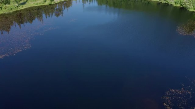 Aerial shot above pond Baklidammen in Bymarka park, near Trondheim