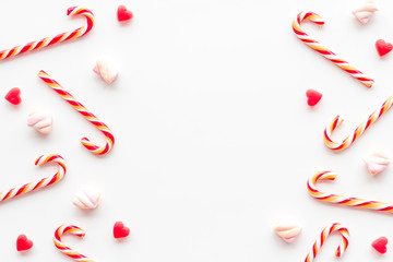 Christmas candies frame on white backgound top-down copy space