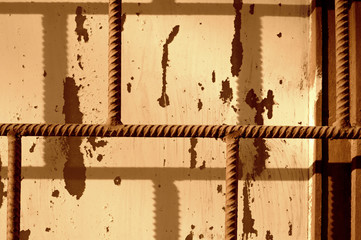 Old painted window behind an iron grate. Toned abstract background