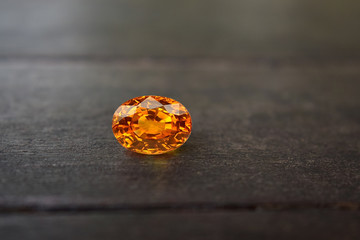 Yellow gem Beautiful on the wooden floor	