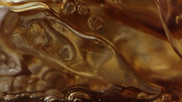 Filling up cup of ice with coffee macro shot, ice drink for morning, bubbles in drink, slow motion, shot on Red Weapon Helium 8k