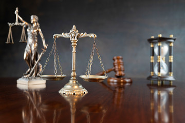 Law theme. Gavel of the judge, Themis statue and scale of justice on gray background.