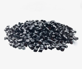 Close-up of black plastic polymer granules on white background